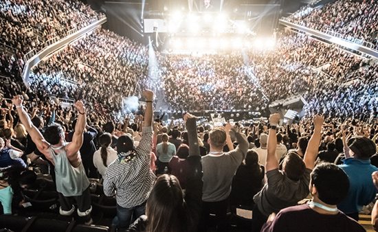 business strategies crowd standing at Tony Robbins event
