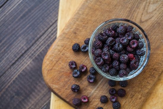 healing superfoods black raspberries on wood table