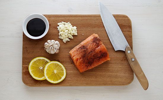 diets that work salmon with garnishments on cutting board
