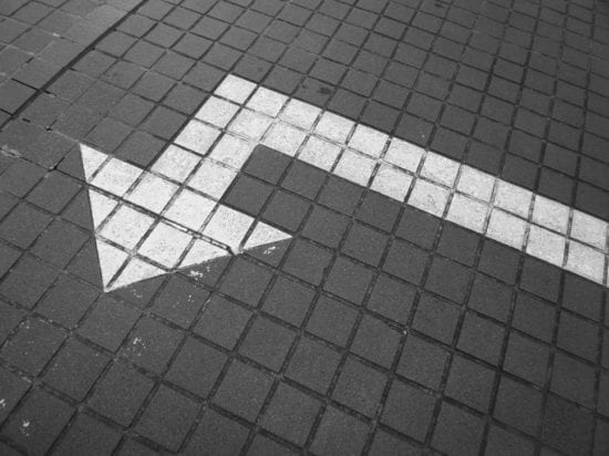 a white arrow painted on the ground