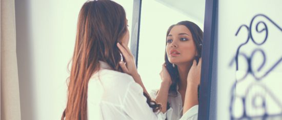 women looking into a mirror self love